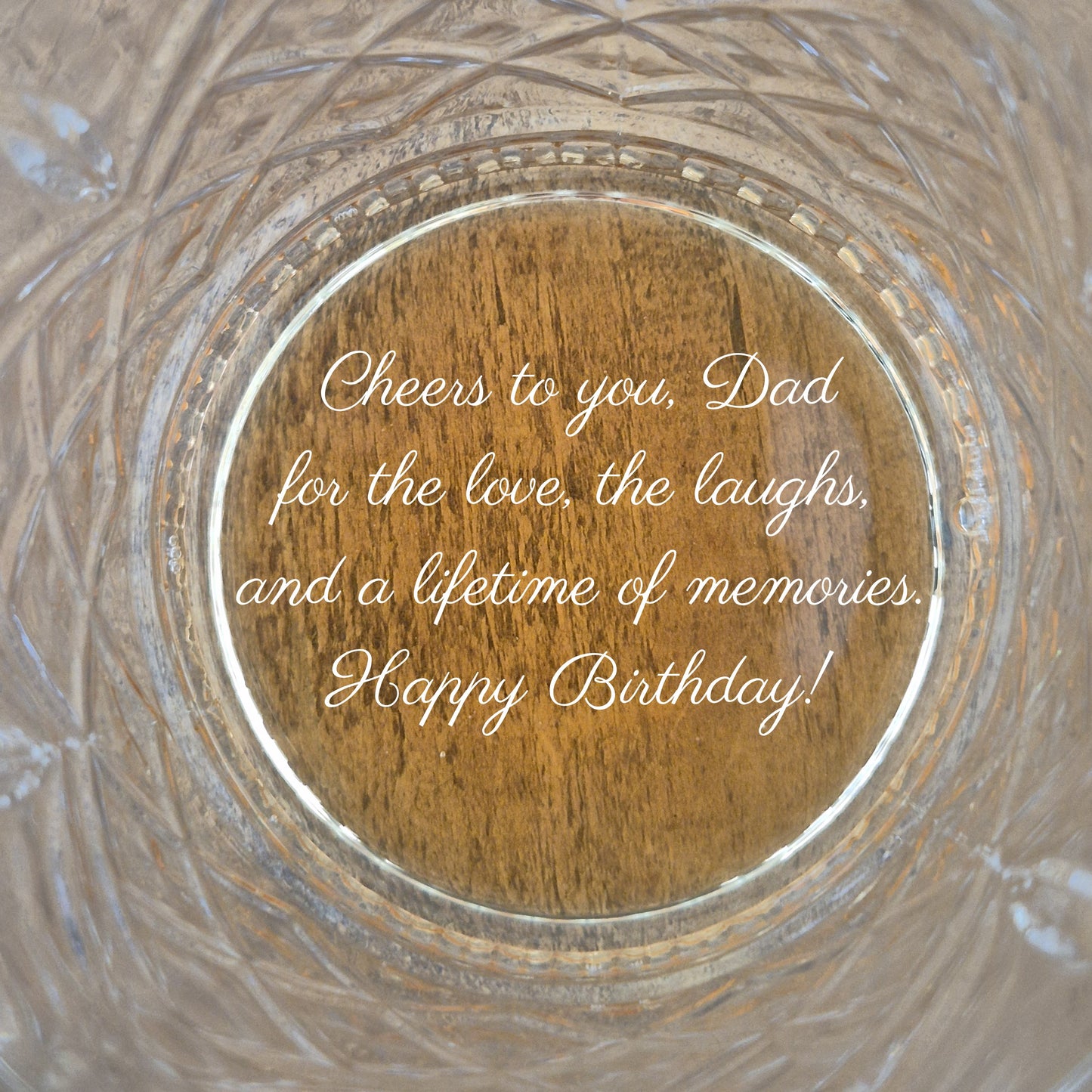 customised whisky glass with an engraved message on the base from a son to his dad.