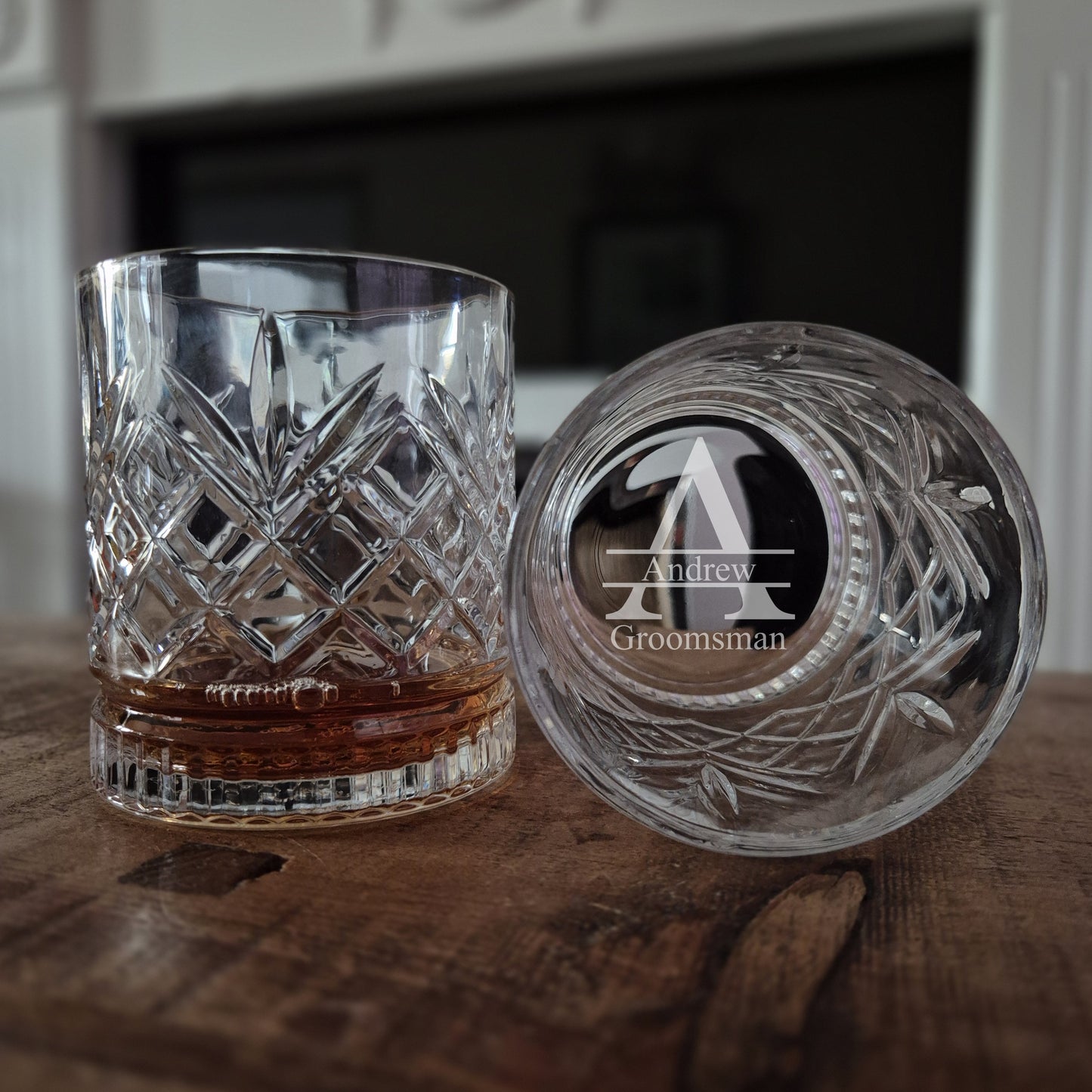 Engraved whisky glass on a table with initials and wedding role engraved in the base
