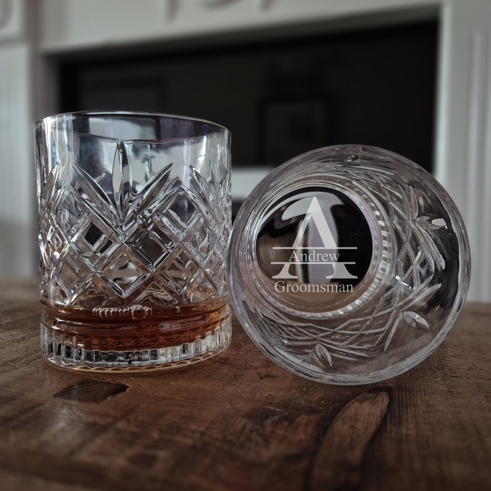 Engraved whisky glass on a table with initials and wedding role engraved in the base
