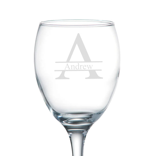 Clear wine glass with engraved 'Andrew' monogram on a white background