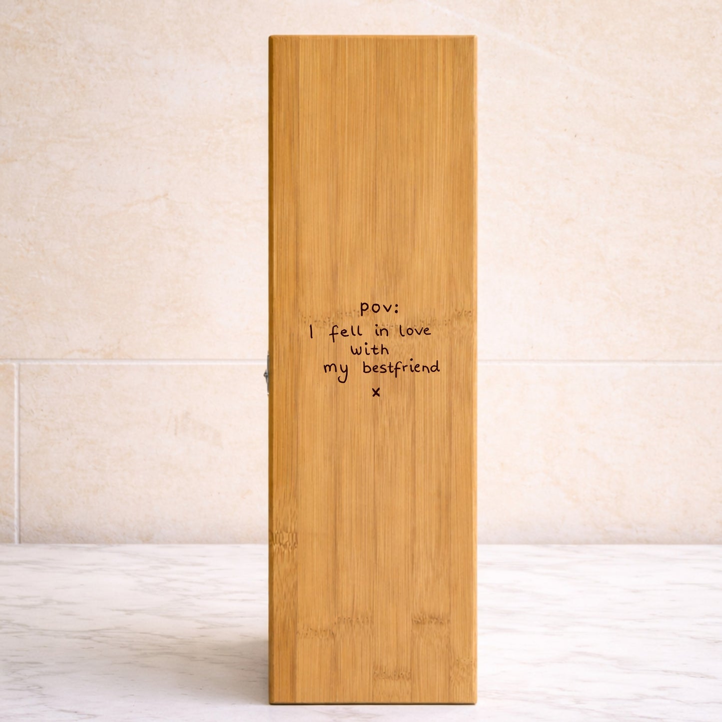 Wooden wine box with engraved text on a light background