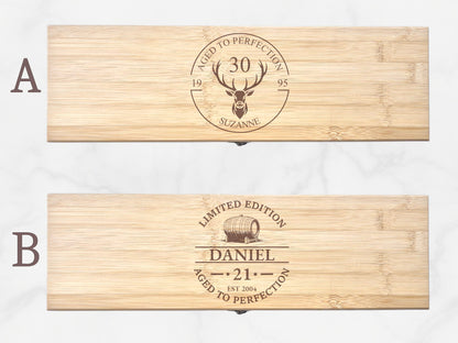 Two wooden boxes with engraved designs on a white background