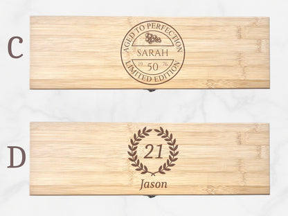 Two wooden boxes with engraved text and designs on a white background