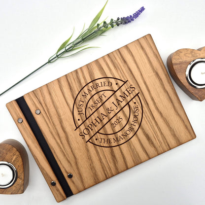 Image of a rustic style oak wedding book. The book is approximately 298mm x 216mm and includes high quality paper. The oak wedding book is laser engraved by laserengraveuk with a circular just married stamp design to the front. The design includes the married couple's names, date of wedding, and the venue.