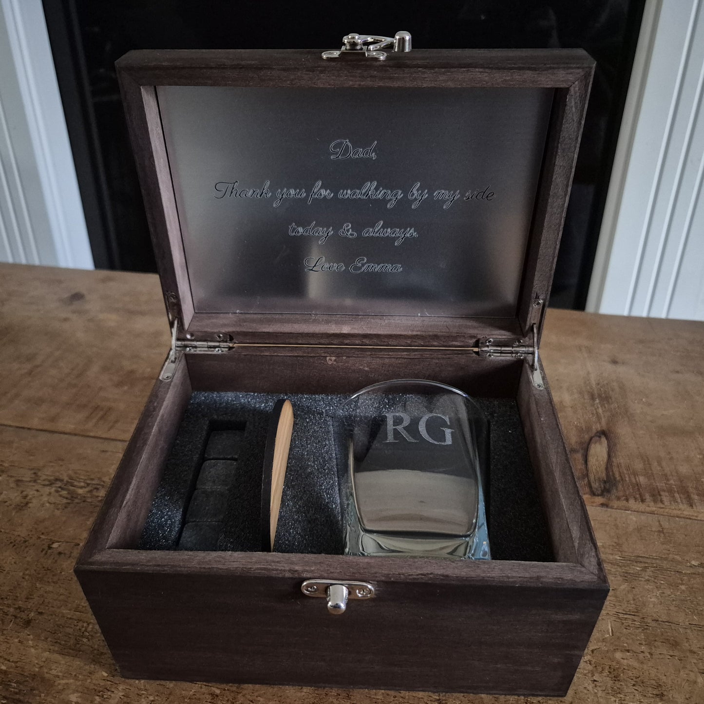 Wooden whisky box with engraved text containing an engraved whiskey glass, stones and oak coaster.