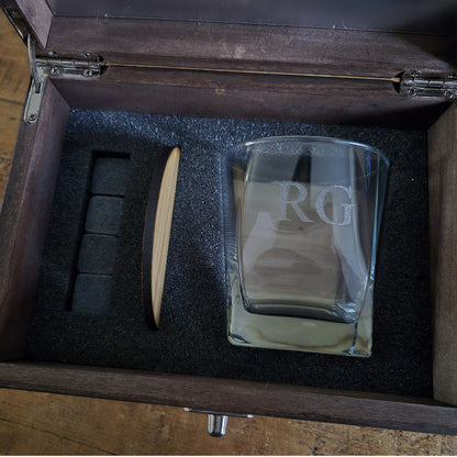 Wooden whisky box with engraved text containing an engraved whiskey glass, stones and oak coaster.