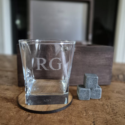 Wooden whisky box with engraved text containing an engraved whiskey glass, stones and oak coaster.