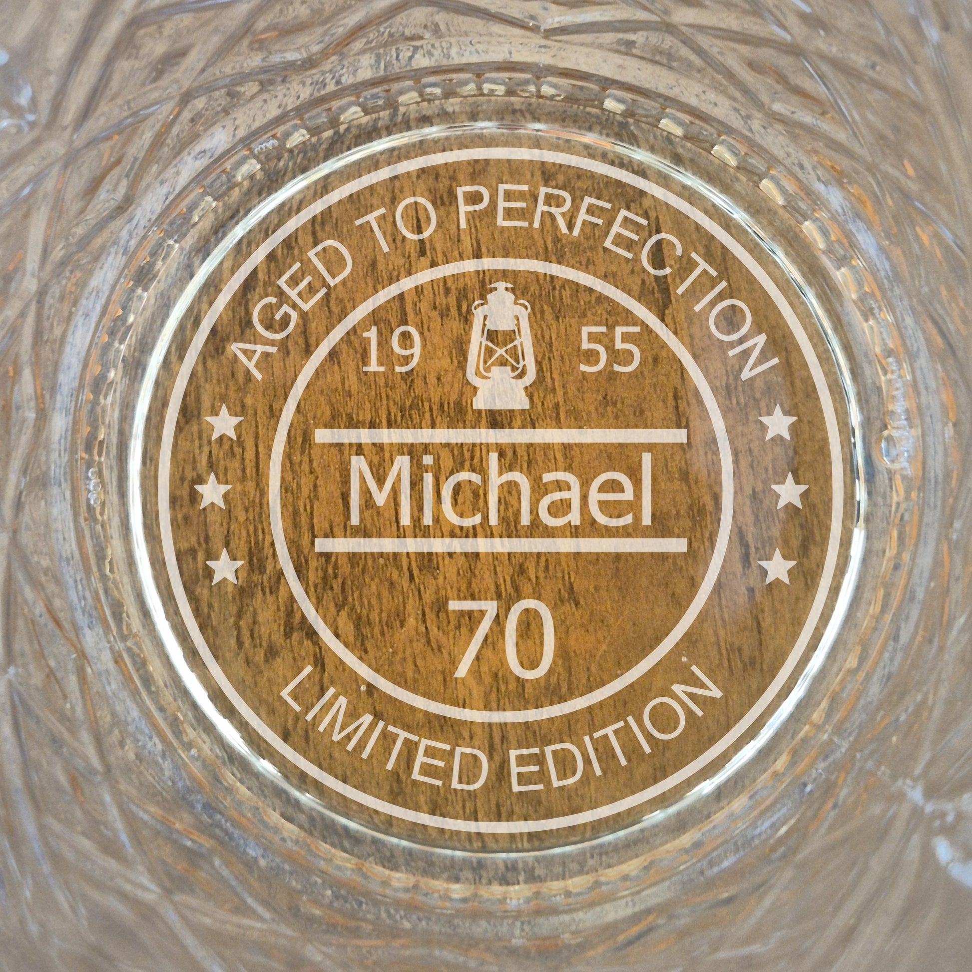 personalised whisky glass with engraved design on a wooden surface