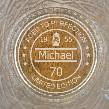 personalised whisky glass with engraved design on a wooden surface