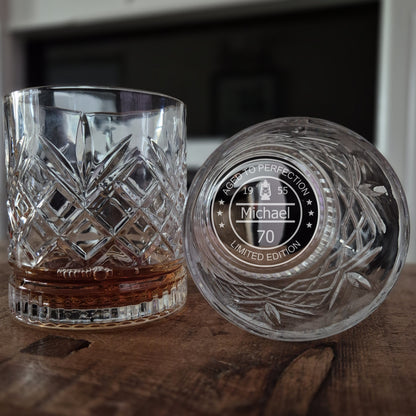 personalised whisky glass with engraved design on a wooden surface