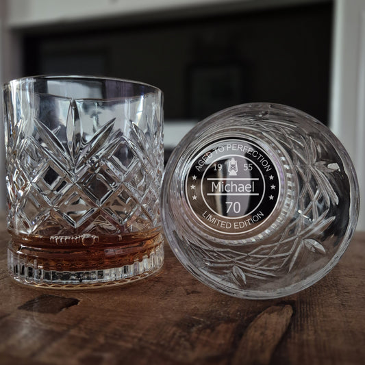 personalised whisky glass with engraved design on a wooden surface