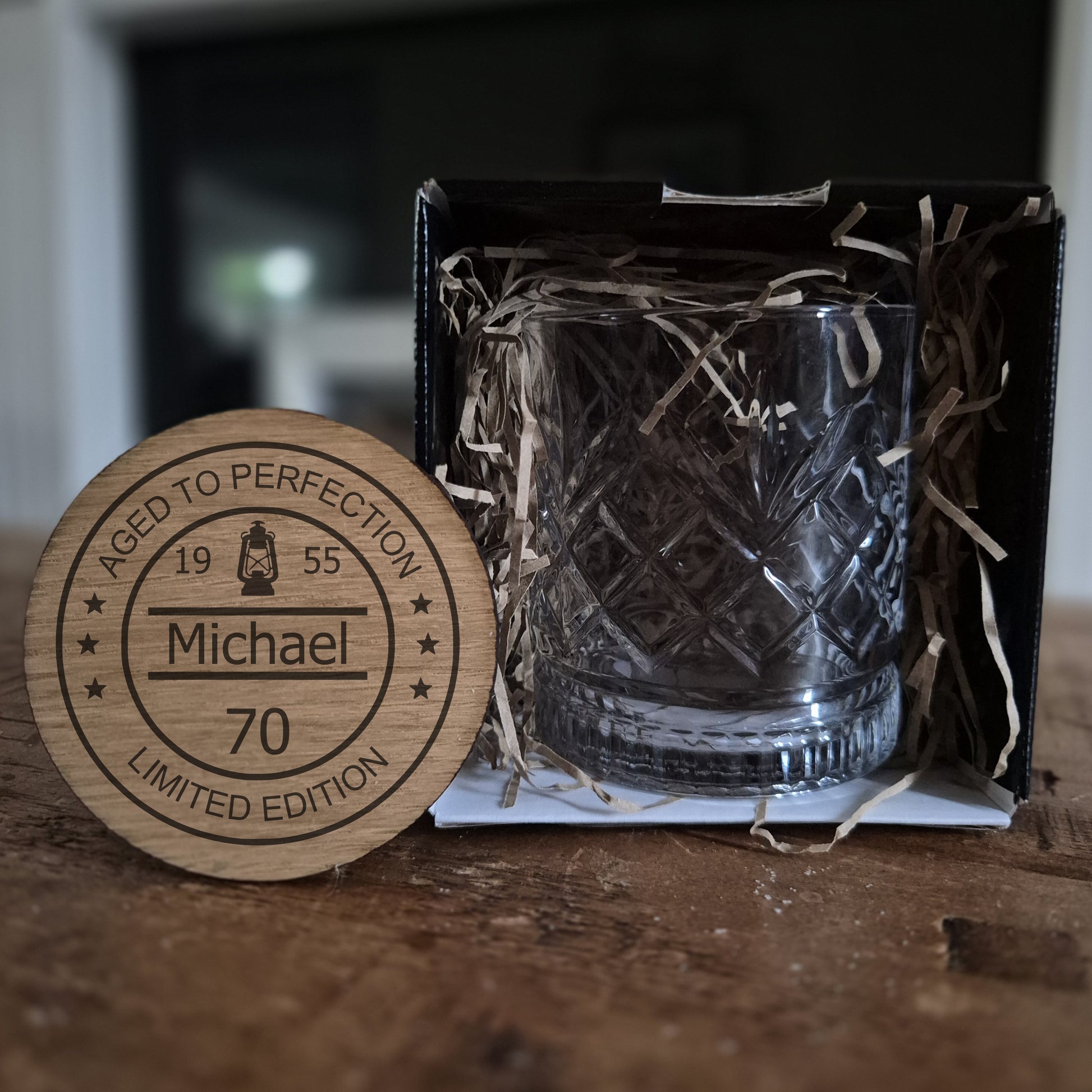 personalised whisky glass with engraved design on a wooden surface