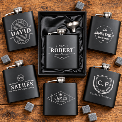 Personalised black 6oz hip flask in a satin-lined gift box with funnel, surrounded by six engraving design examples