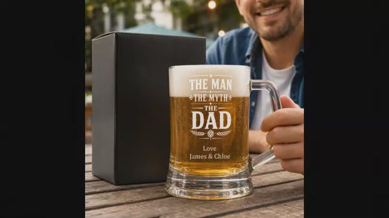 Video showing a man icking up an engraved beer mug with "TheMan, The Myth, The Dad" engraved on the front.
